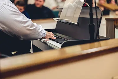 Pianist playing during worship service at Fellowship Baptist Church