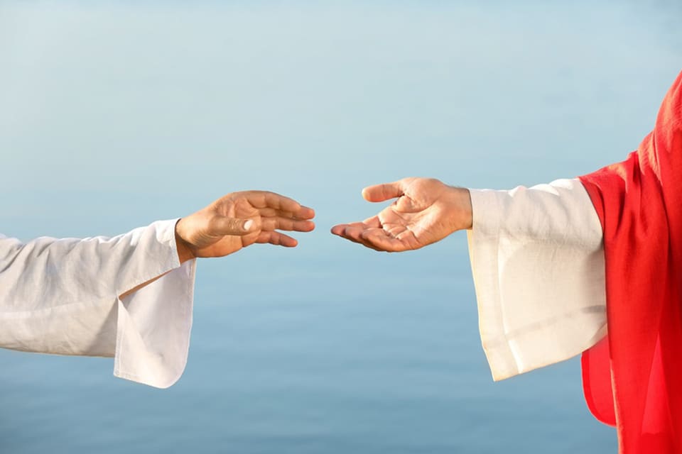 Jesus reaching out His hand symbolizing salvation and personal relationship with God